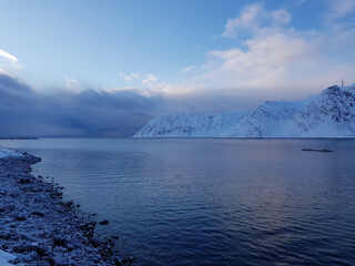 Snowy mountain and blue fjord lanscape in the arctic circle