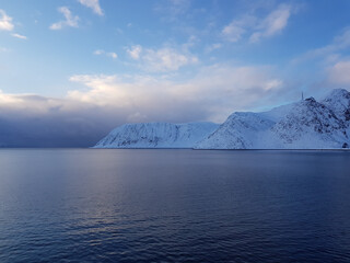 Snowy mountain and blue fjord lanscape in the arctic circle