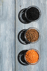 Red, black, brown seeds of dry lentils
