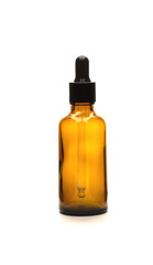 Brown bottle with dropper for essential oils on white background, isolate