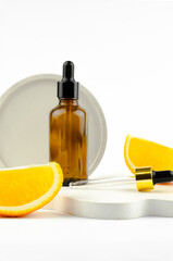 Aromatic cosmetic product for skin and hair care. Serum in a glass bottle with a pipette. Packaging for a cosmetic product. Oils with orange extract