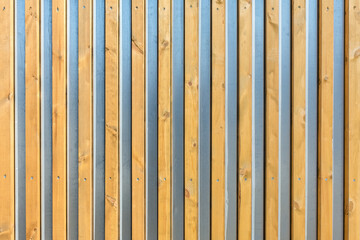 the metal surface is decorated with wooden slats as a natural background
