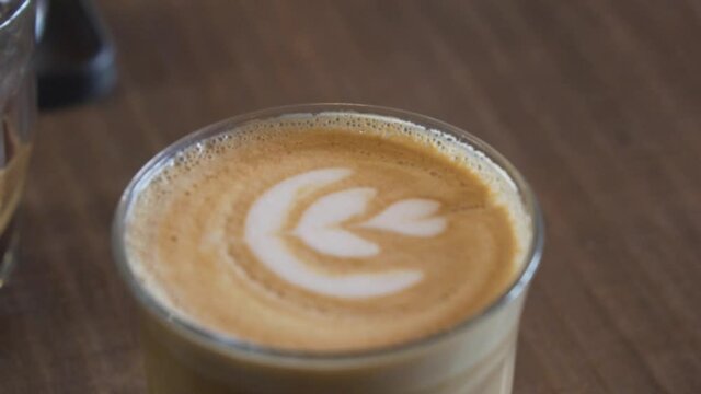 Glass Of Cold Brewed Espresso With Perfect Latte Art Served At Coffee Shop. close up, rack focus