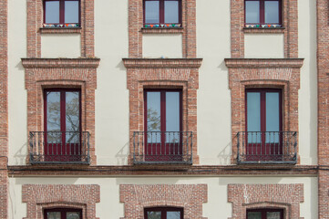 Fototapeta na wymiar three independent balconies with brick lintel and iron railing