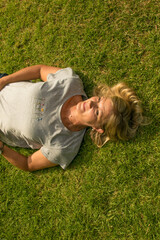Fototapeta premium Pretty baby boomer lying on grass
