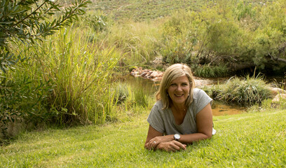 Blonde 50-year old pretty woman in nature