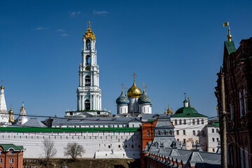golden towers and ancient architectural solutions of the Trinity-Sergievskaya Lavra in Sergiev Posad on a sunny spring day 