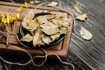 Dry bay leaf spices on wooden background