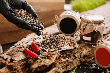 Dry seeds of pepper and raw fresh pepper on wooden background