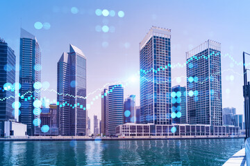 Obraz premium Skyscrapers of Dubai business downtown. International hub of trading and financial services of Western Asia. FOREX graph and chart concept. Double exposure. Dubai Canal waterfront.