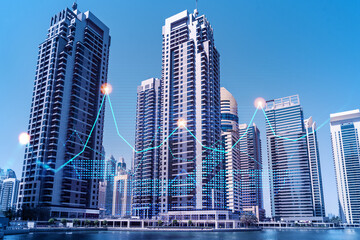 Fototapeta premium Skyscrapers of Dubai business downtown. International hub of trading and financial services of Western Asia. FOREX graph and chart concept. Double exposure. Dubai Canal waterfront.