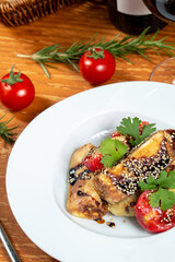 Eggplant and tomato salad with soy sauce and sesame seeds