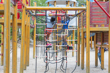 Parents with children are relaxing in a children's amusement park on a summer day. Europe. Kolmorden, Sweden. 