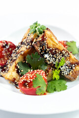 Eggplant and tomato salad with soy sauce and sesame seeds