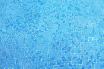 Fototapeta na wymiar Clean clear water in the pool. Blue small tile. Top view. Background. Texture.