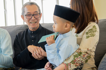 Eid Mubarak celebration moment, grand father with grand son