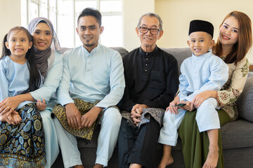 Eid Mubarak celebration moment, family wearing traditional cloth smiling