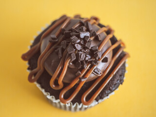 chocolate cupcake with yellow background