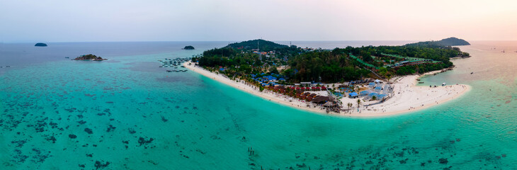 Fototapeta na wymiar aerial bird eye panorama view of Lipe islands in evening, Satun, Thailand, peaceful landscape sea, green-blue ocean, green mountain, travel and relax place, drone high angle top view