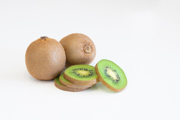 Whole fresh kiwi fruit and slices isolatet on white background with copy space for text