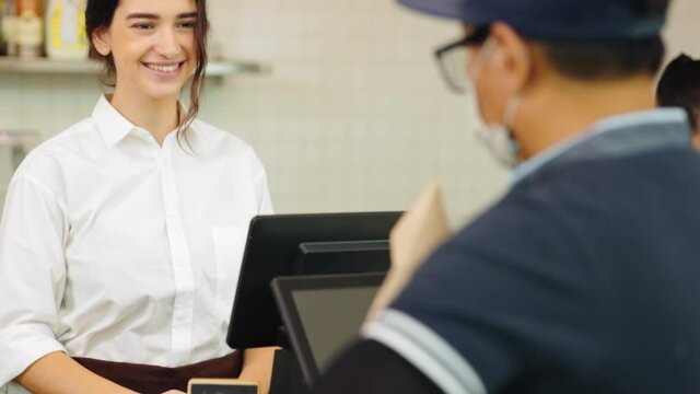 Customer paying with qr code on smartphone screen NFC payment technology at coffee shop.Midsection of female staff showing contactless menu QR code on digital mobile.