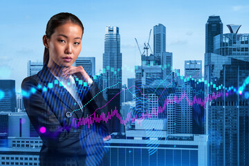 Attractive young Asian trader and stock market analyst in suit dreaming about market behavior and...