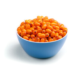 Buckthorn berries in a bowl. Isolated on a white background.