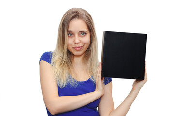 A young beautiful smiling caucasian blonde woman in a blue t-shirt holds a square black box with an copy empty space for text and design on a white background. Board, blank, template, mockup, layout