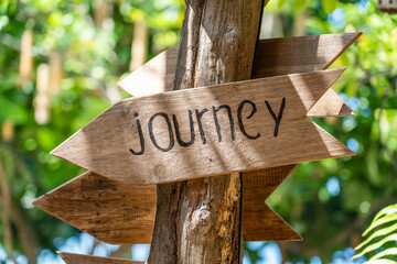 Text journey on a wooden board near tropical hotel in island Koh Phangan, Thailand. Journey wooden sign inscription in the asian tropics, close up