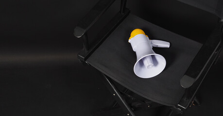 BLACK director chair and megaphone on black background.it use in video production or film and cinema industry.
