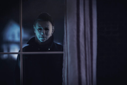 NEW YORK USA: APRIL 14 2021: Halloween horror movie slasher Michael Myers staring through a window at the Doyle house - Trick or Treat Studios action figure