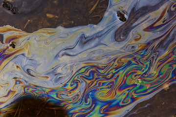 oil spills on puddle background, abstract gasoline nature pollution concept