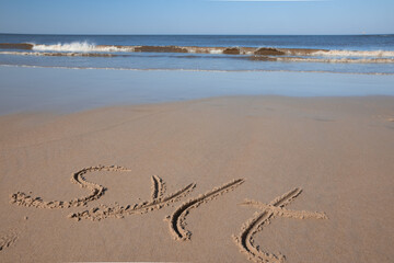 Wort "Sylt" in den Sand gemalt am Nordsee Strand