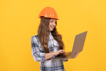 happy teen girl in helmet and checkered shirt using laptop, education