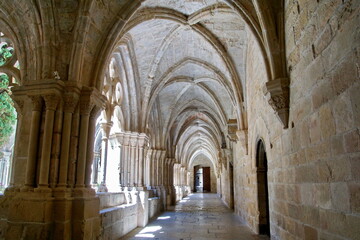 Fototapeta na wymiar Detail of the cloister of Santa Maria de Poblet Monastery, Unesco heritage. Romanesque cloister architecture in Poblet, Spain.
