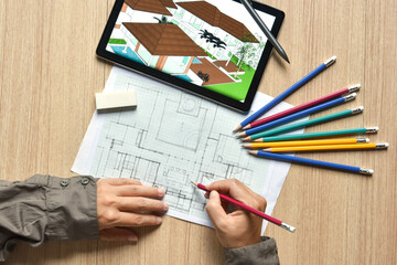 a tablet showing architectural drawing design detail building perspective and draft plan with digital pens on wood table, the concept of new technology for working of tablet with digital pen