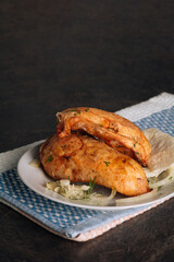 Delicious grilled chicken breasts on a plate on the dark background