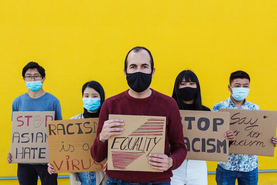 Group Of Multiracial Demonstrators Wearing Protective Masks Protesting On The Street For Equal Rights - European Man With Asian People From Different Countries Fight For Racism