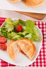Puff pastry filled with tomato and mozzarella cheese.