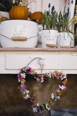 Furniture with white pots and pumpkins with a wreath