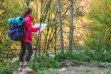 woman with map on the road practicing hiking