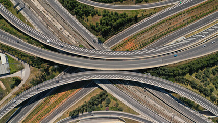 Aerial drone photo of multilevel highway intersection junction toll road outside city urban center