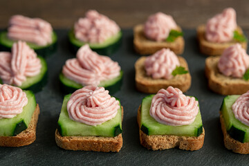 Variety of toasts with taramasalata on a slate board close-up