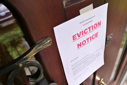 the notice of eviction of tenants hangs on the door of the house, front view