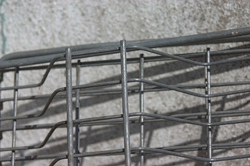 gray metal grating near the concrete wall