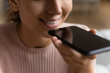 Voice recognition tech. Close up shot of smiling young woman user enjoy modern innovated technology...