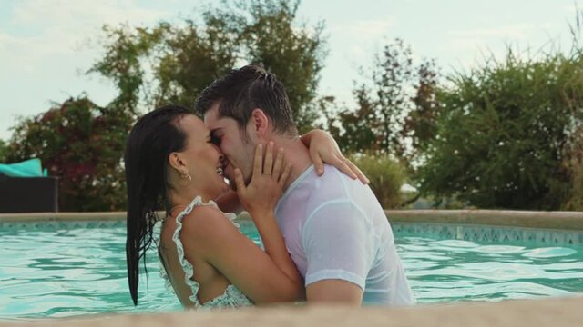 Romantic Man and Woman Kiss and Laugh in Swimming Pool, Slow Motion Closeup
