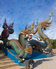 Dragon guards - exterior detail of Famous Wat Rong Suea Ten, or Blue Temple in Chiangrai, Chiang Rai Province, Northern Thailand