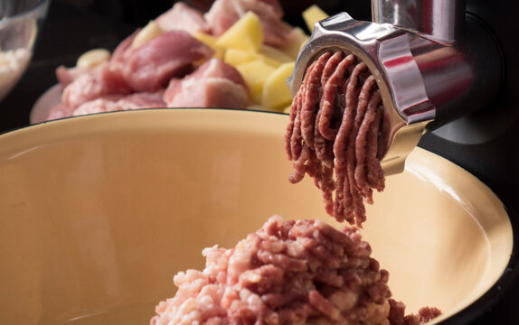 Cooking minced meat in an electric meat grinder from fresh meat at home.