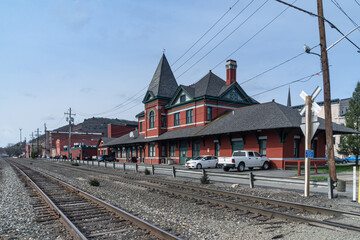Fototapeta na wymiar Port Jervis, NY - USA - April 10,2021: a landscape view of the historic Port Jervis station. Built in 1892 as a passenger station for the Erie Railroad by Grattan and Jennings in the Queen Anne style.